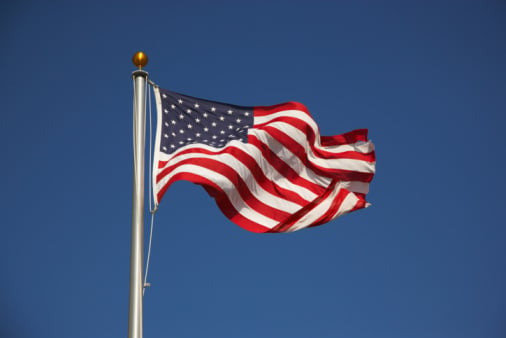 American flag on pole waving in breeze